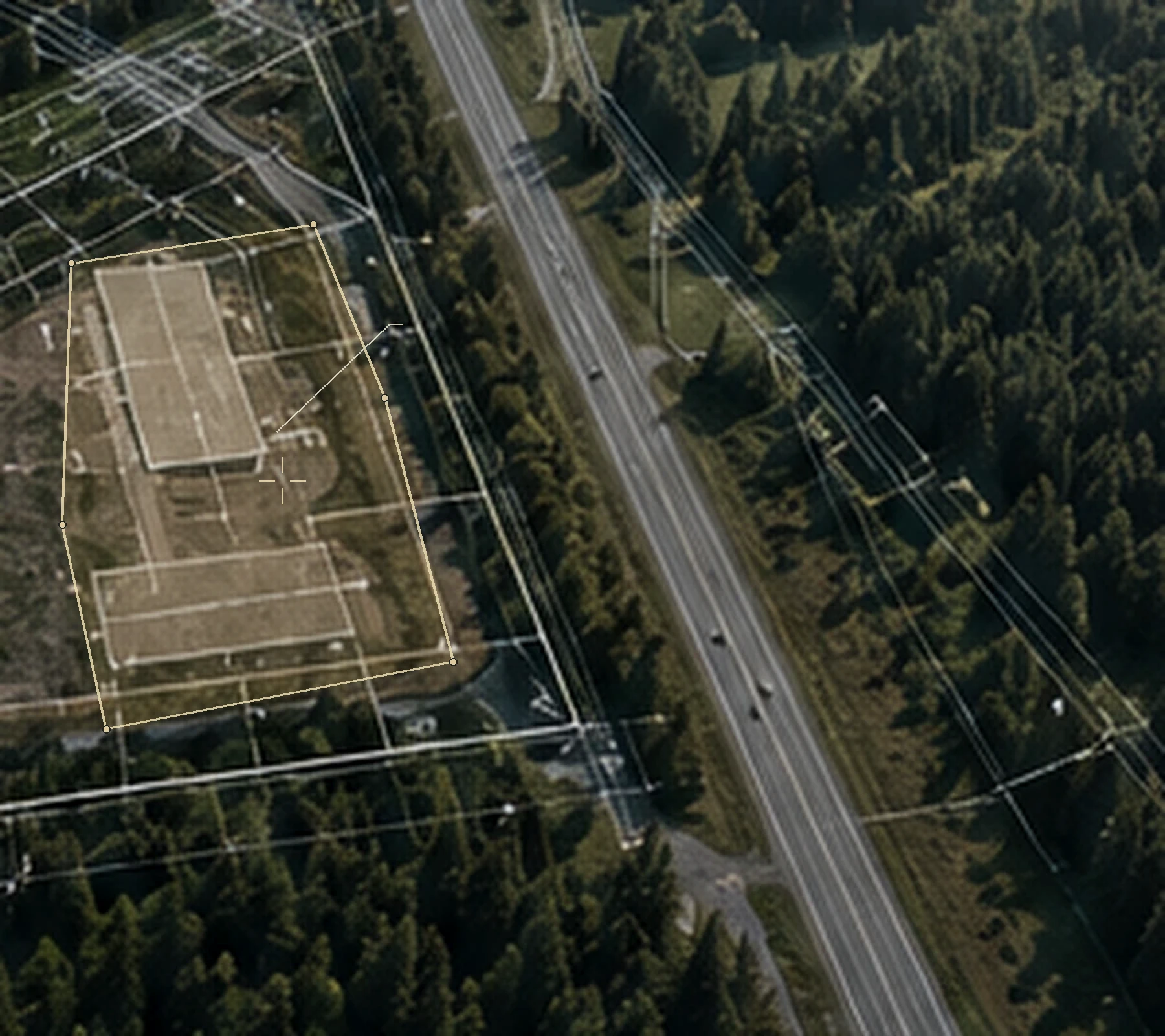 Aerial perspective of wooded candidate land with an adjoining access road